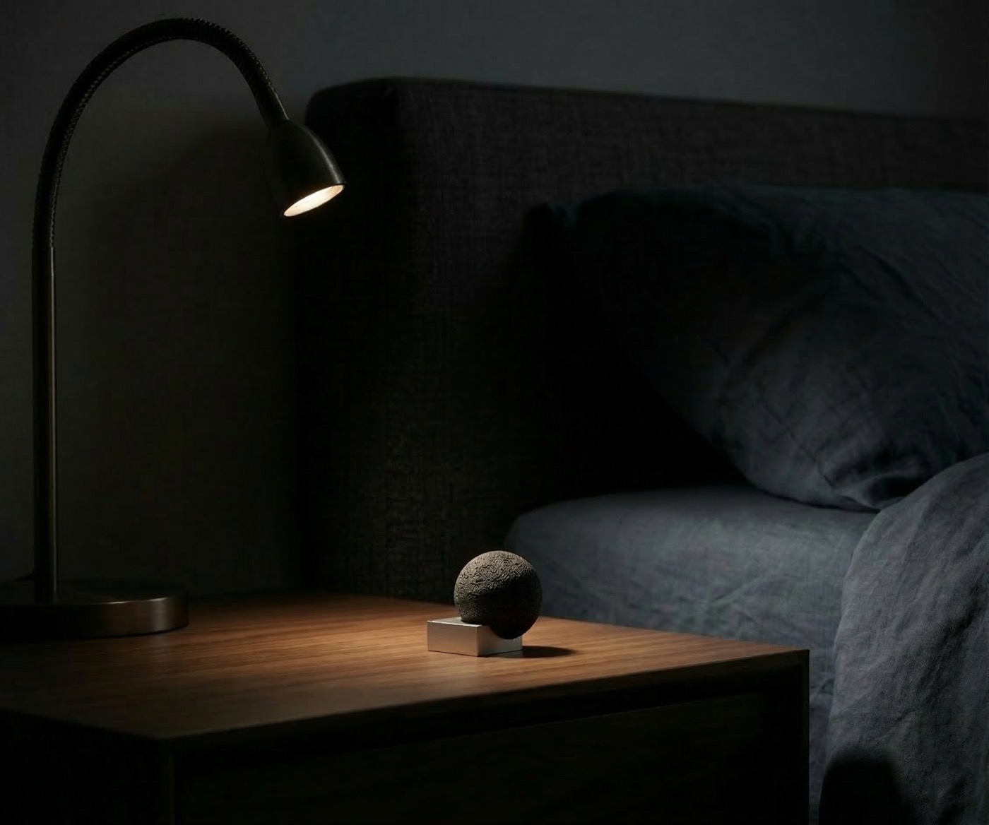 Moon Rock diffuser glowing softly on a bedside table at night